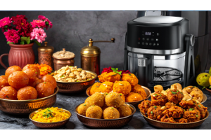 Air fryer with Indian sweets and savory snacks.