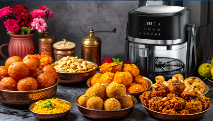 Air fryer with Indian sweets and savory snacks.